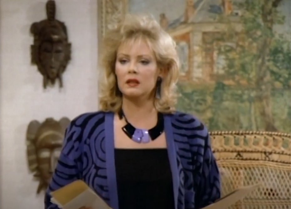 A woman (Jean Smart) holding envelopes and letters in her both hands