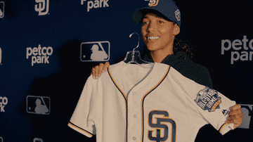 girl holds up a jersey