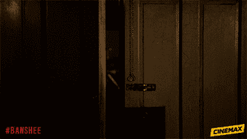 a man walks through a door