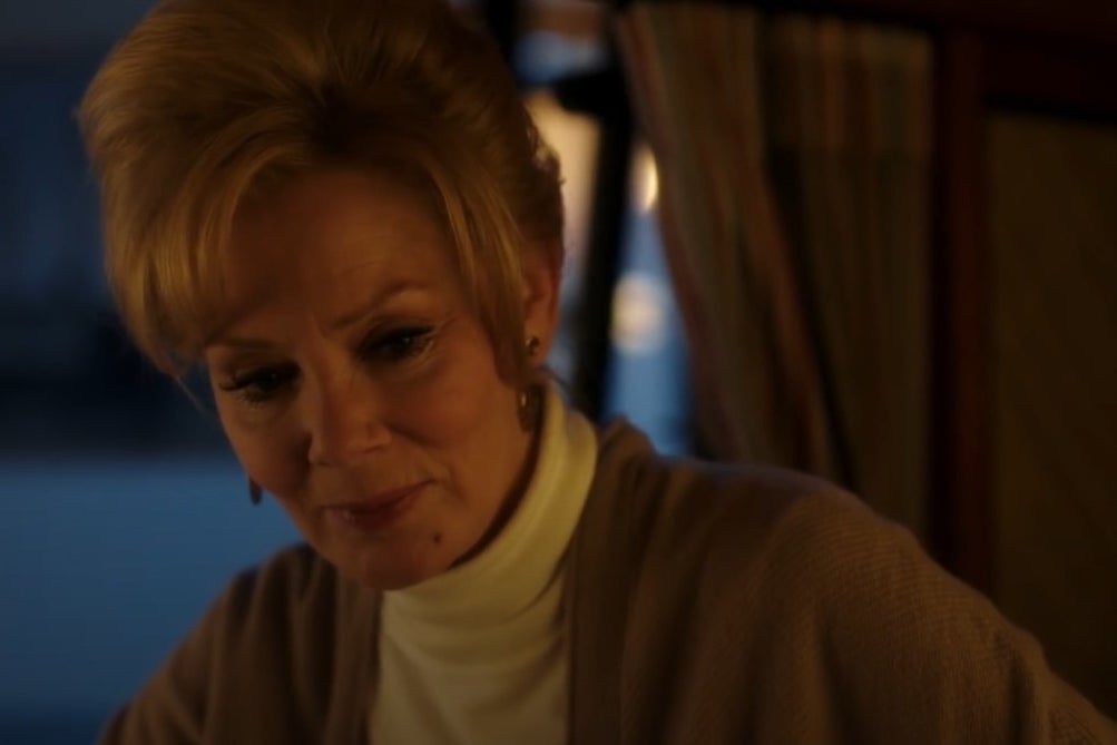 A woman (Jean Smart) looking at something below