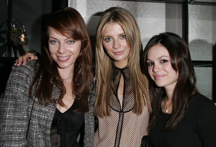 Rachel, Melinda, and Mischa pose close together at an event 