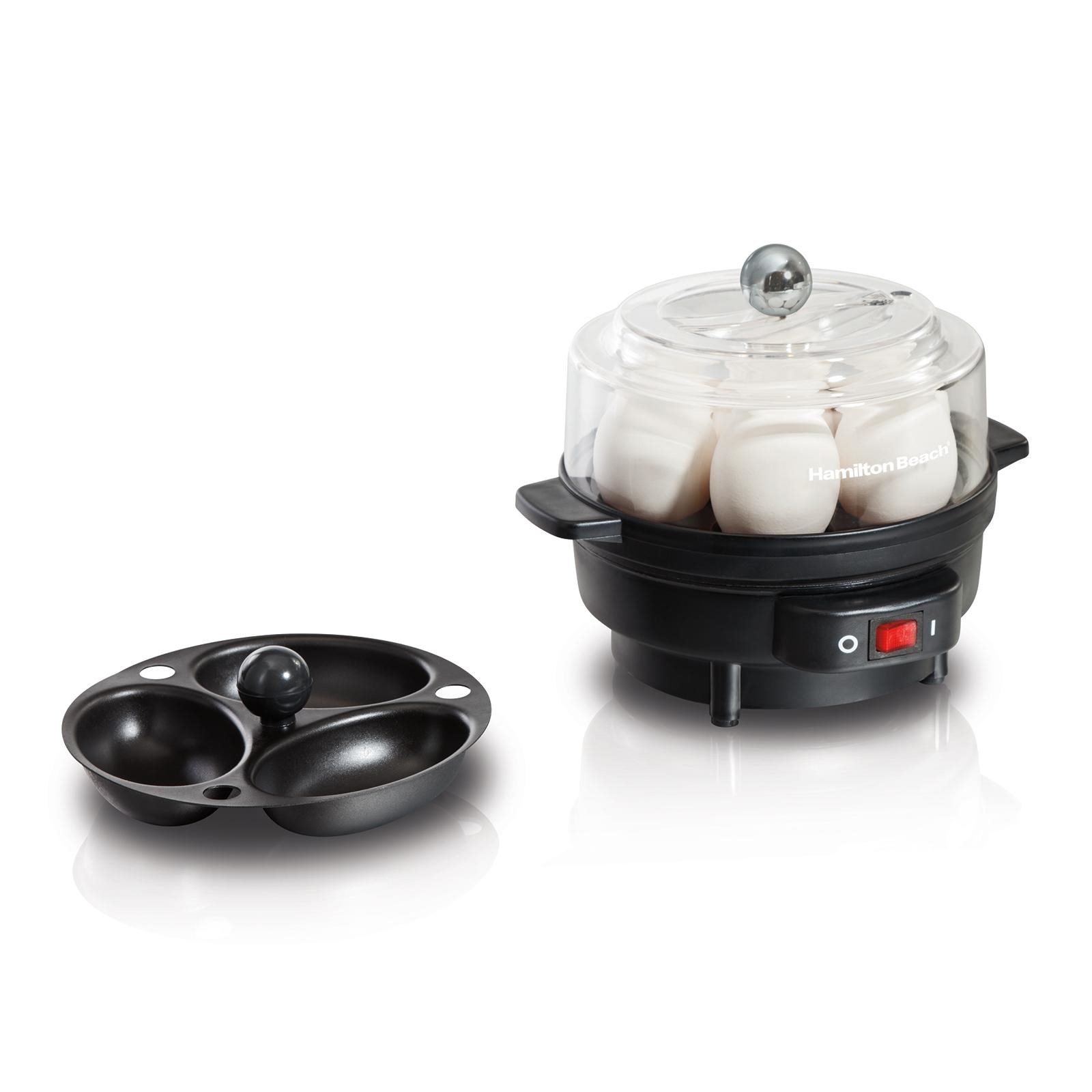 black egg cooker filled with eggs next to egg poacher dish