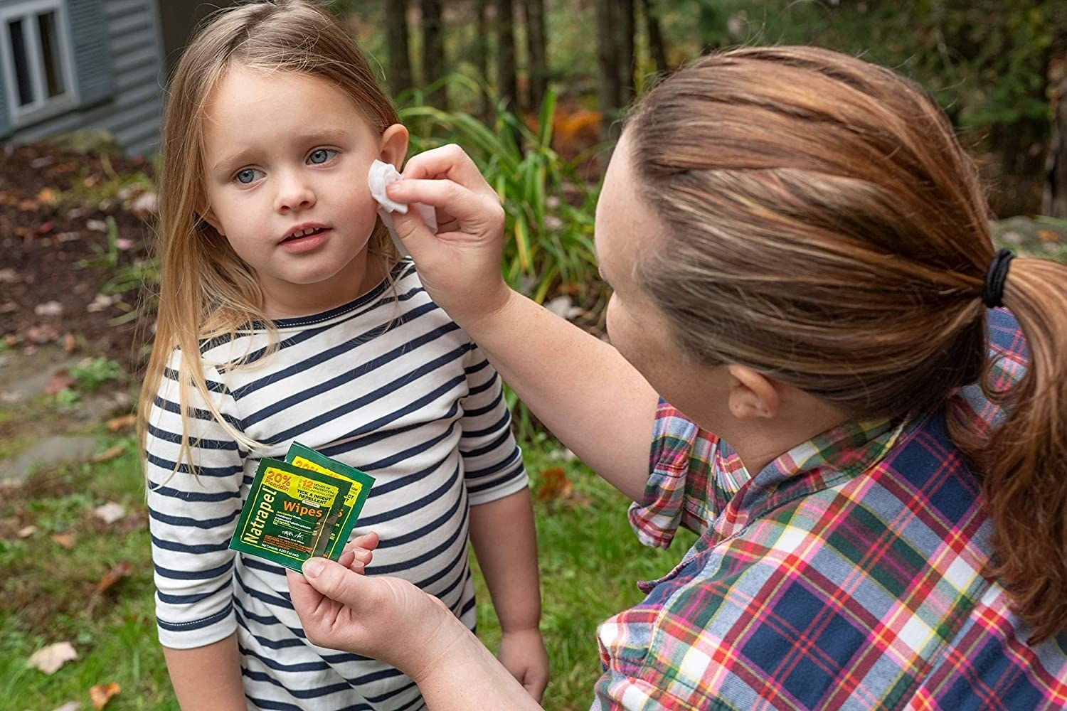 parent using the wipe on a kid's face