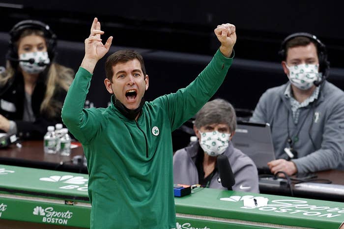 Brad Stevens coaching with his arms raised while yelling