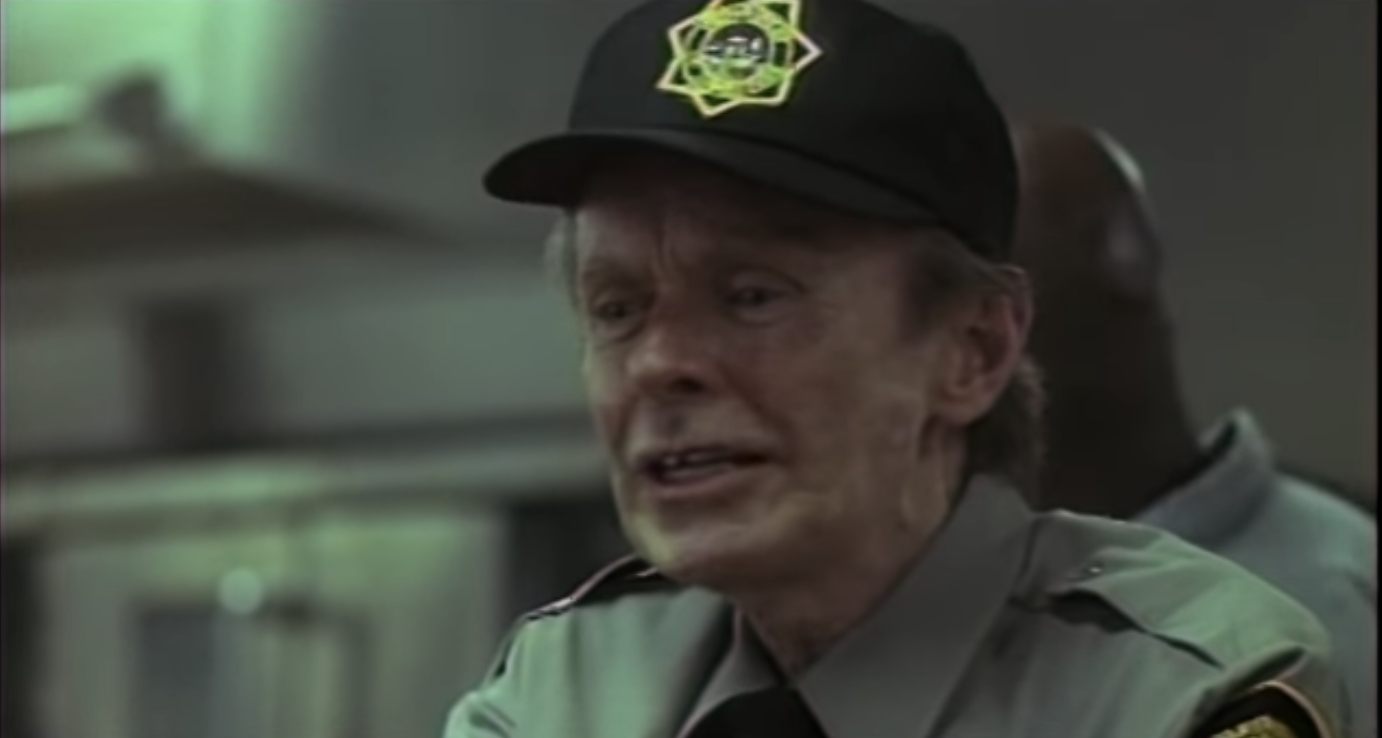 Hubert Selby Jr. as a racist prison guard