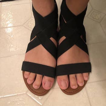 a reviewer wearing the sandals in black