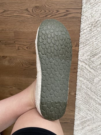Reviewer showing the bottom of her slipper