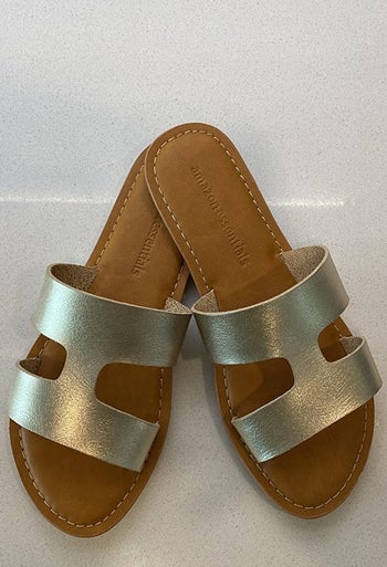 a reviewer's gold sandals