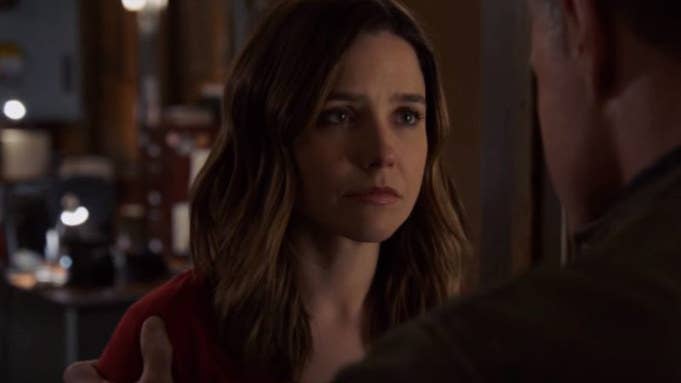 Erin Lindsay (Sophia Bush) looks concerned, making eye contact with a man off-screen.