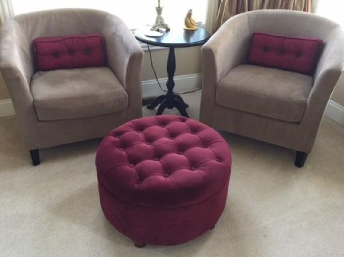 The round tufted ottoman in berry
