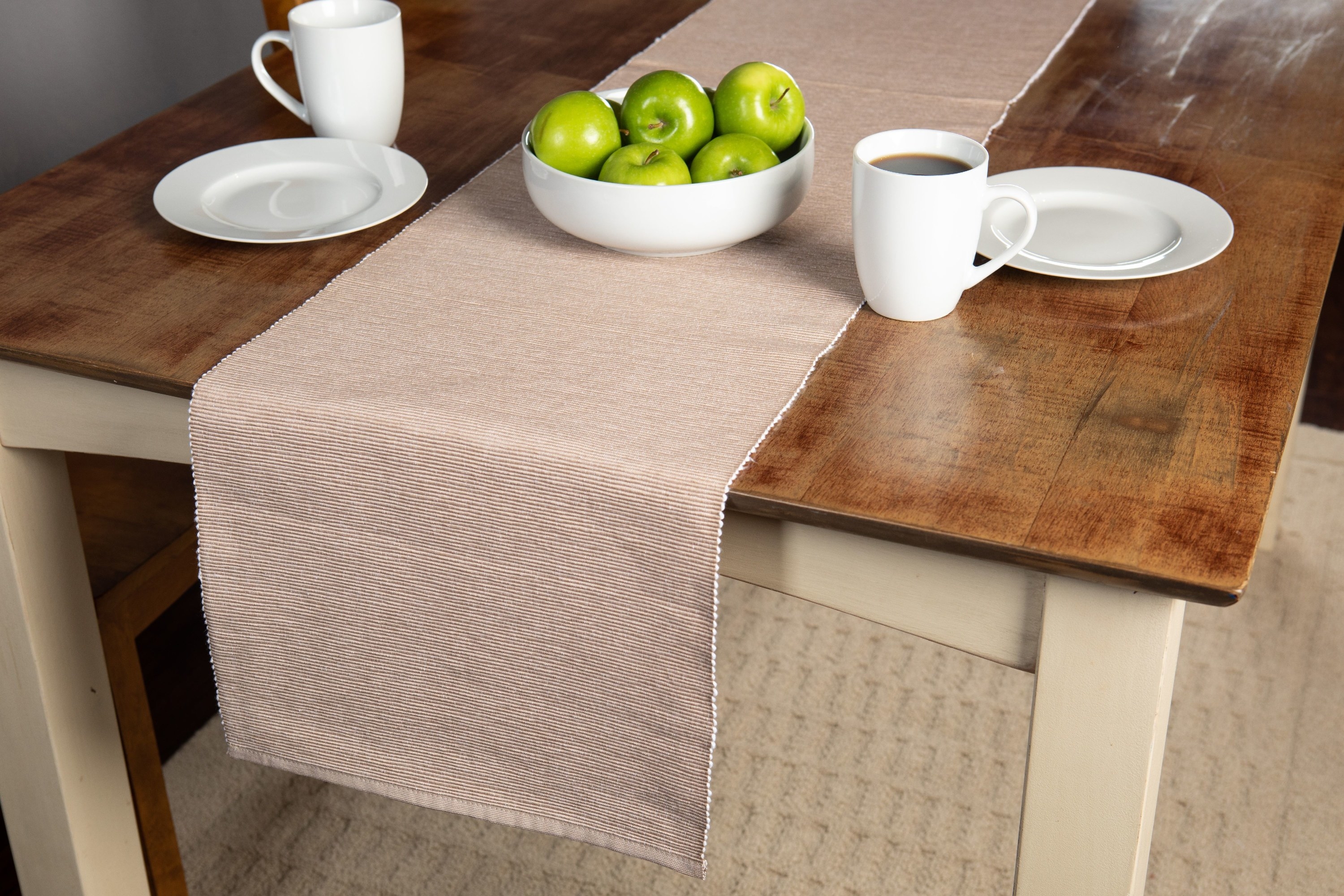 A tan table runner on a wood table