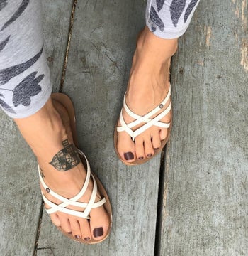 a reviewer wearing the sandals in white