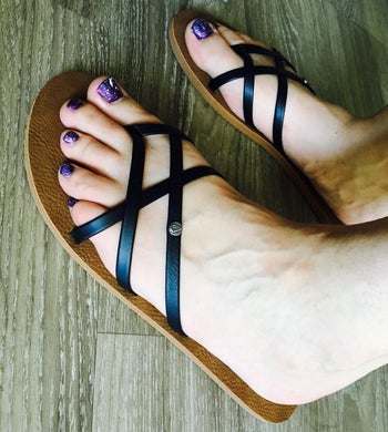 a different reviewer wearing the sandals in black and brown