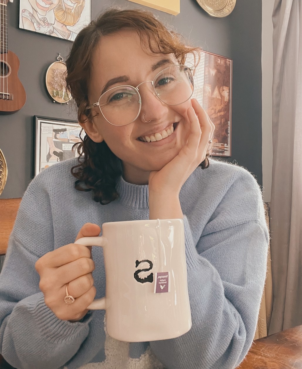 A person holding a mug of hot tea