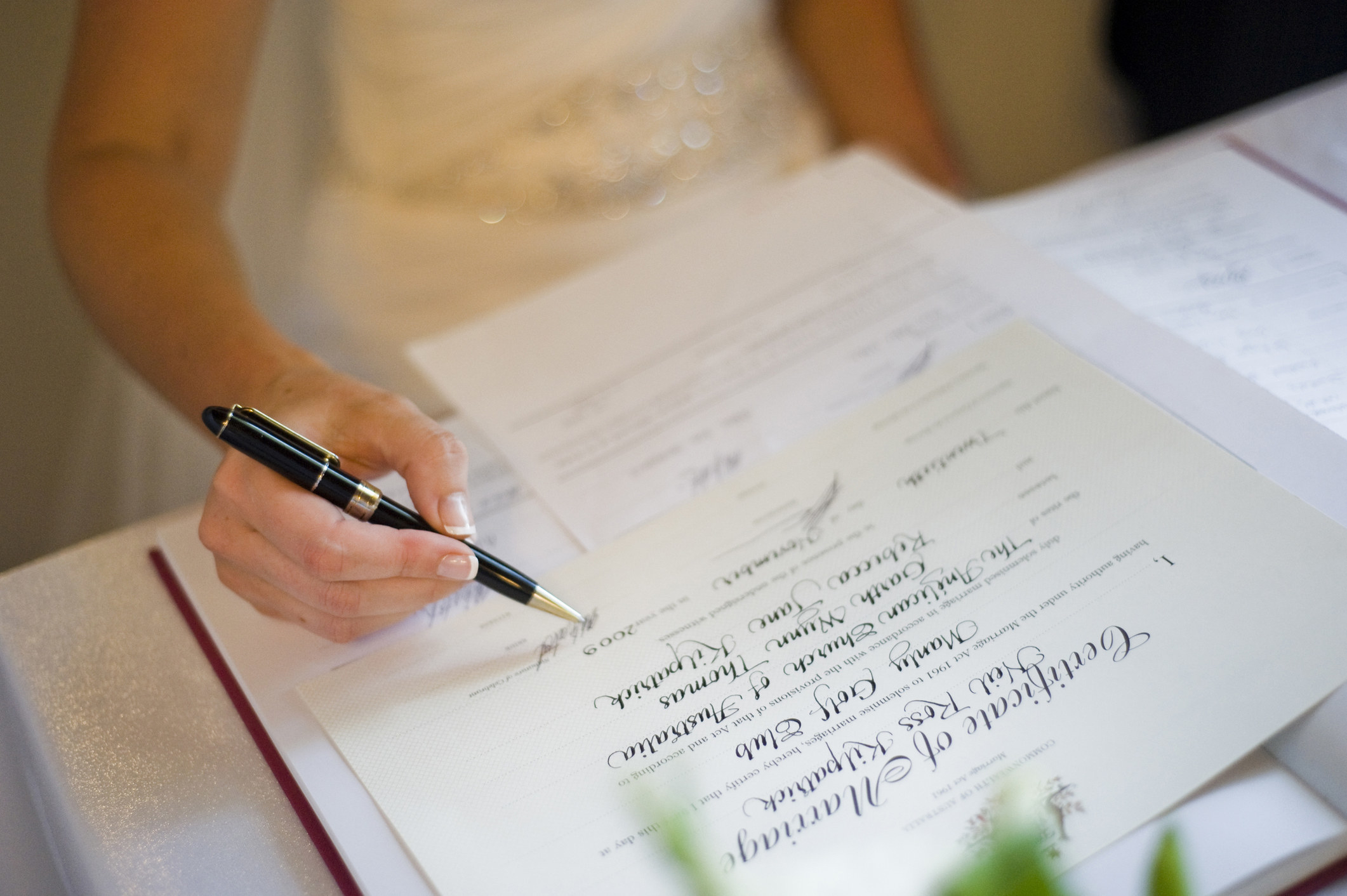 Someone signing a marriage certifercate 