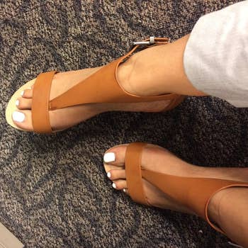 a different reviewer wearing the sandals in brown