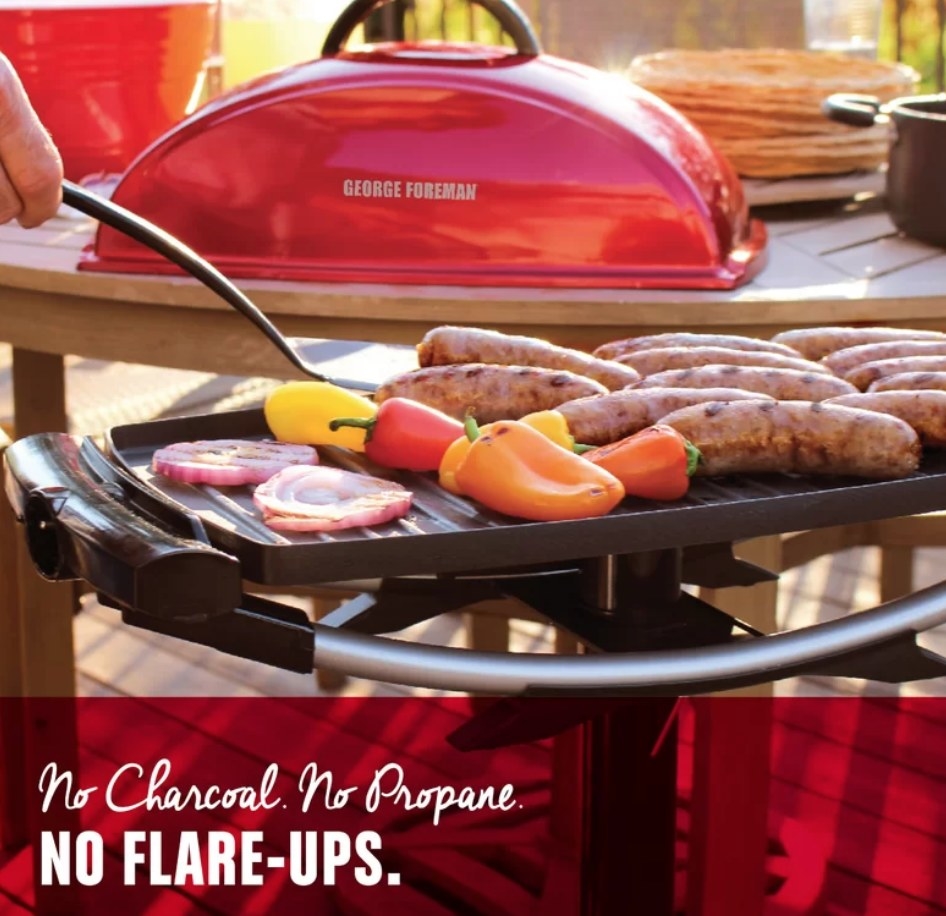 A red, non-stick, George Foreman grill cooking veggies and sausages