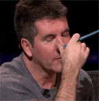 Simon Cowell rubbing his eyes in exhaustion