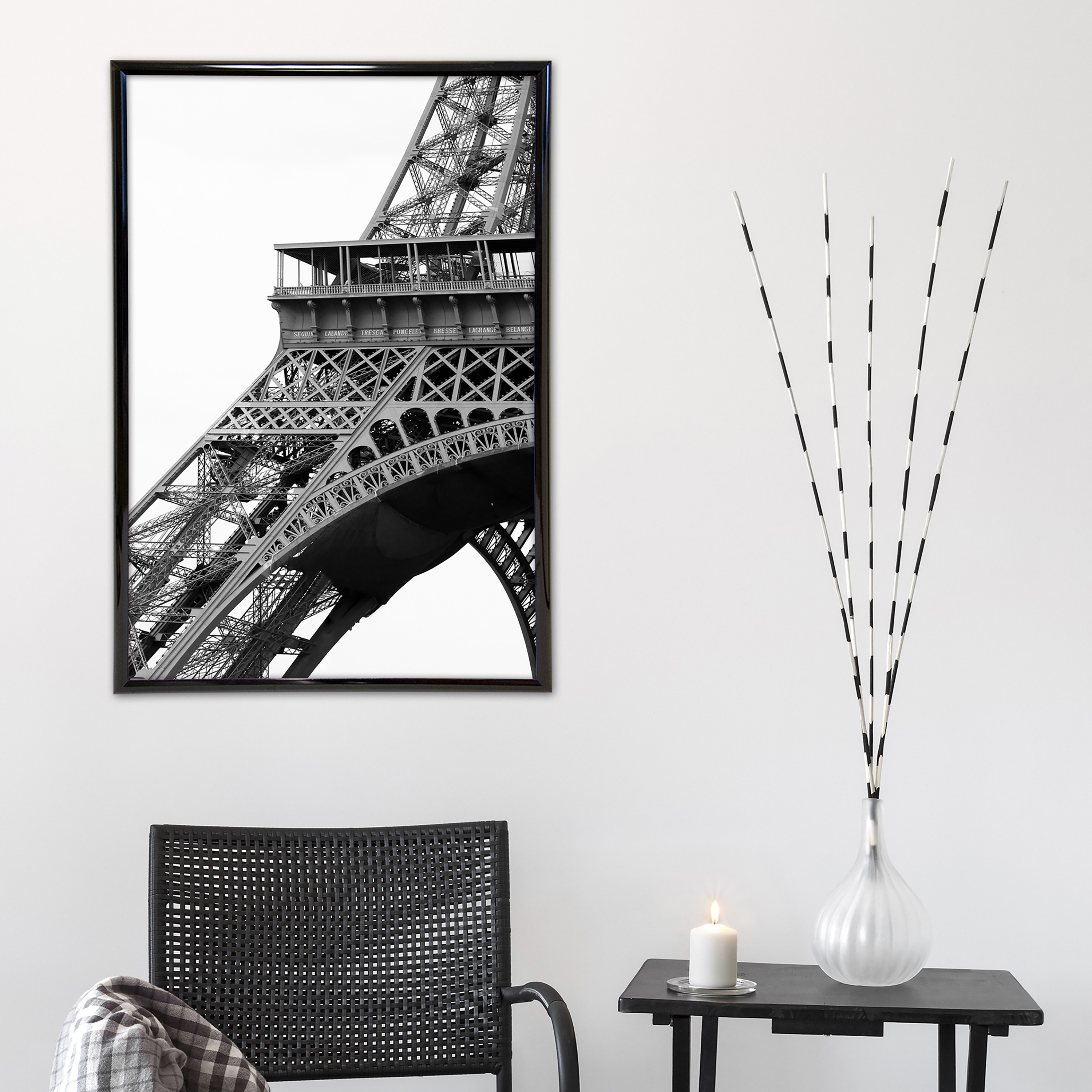 A black poster frame with a photo of the Eiffel Tower in it 
