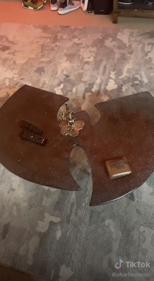 A sparkly coffee table in the shape of the Wu-Tang Clan&#x27;s logo