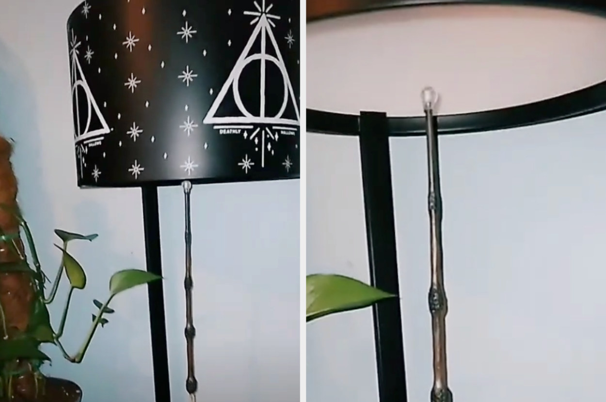 A lamp with the Deathly Hallows symbol on the shade, and a replica of Dumbledore&#x27;s wand rising up from the base, with a tiny light bulb on the end of the wand