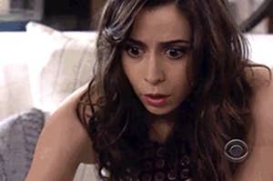 Woman looking shocked at her screen