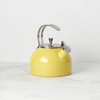 yellow kettle with cap that says 