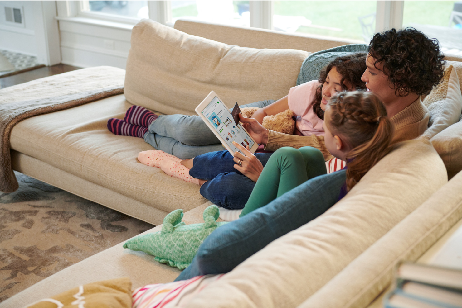 A family shops online together in their living room.