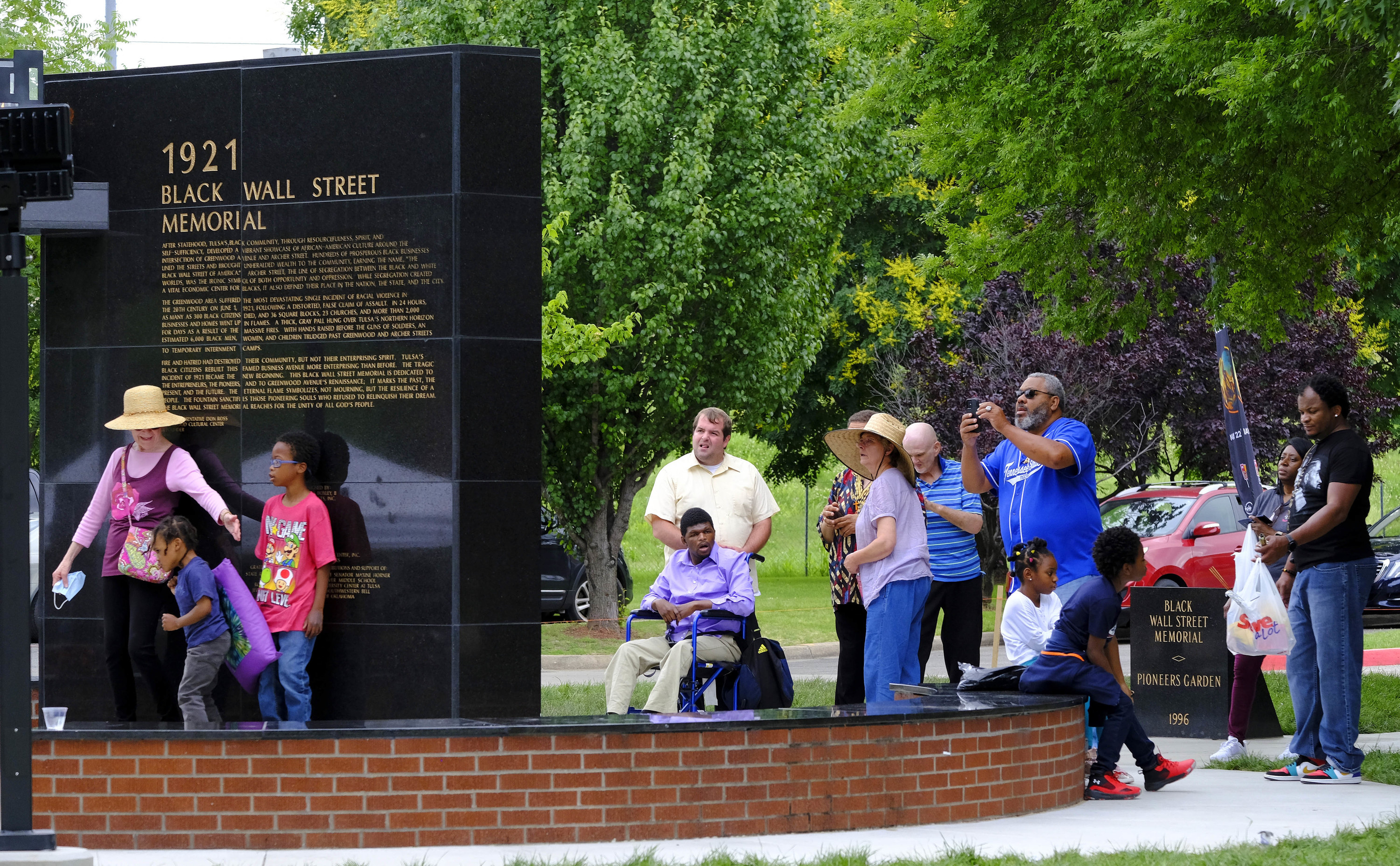 A black monolithic structure is labeled &quot;1921 Black Wall Street Memorial&quot;