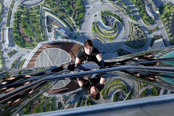 Tom Cruise climbing a skyscraper.