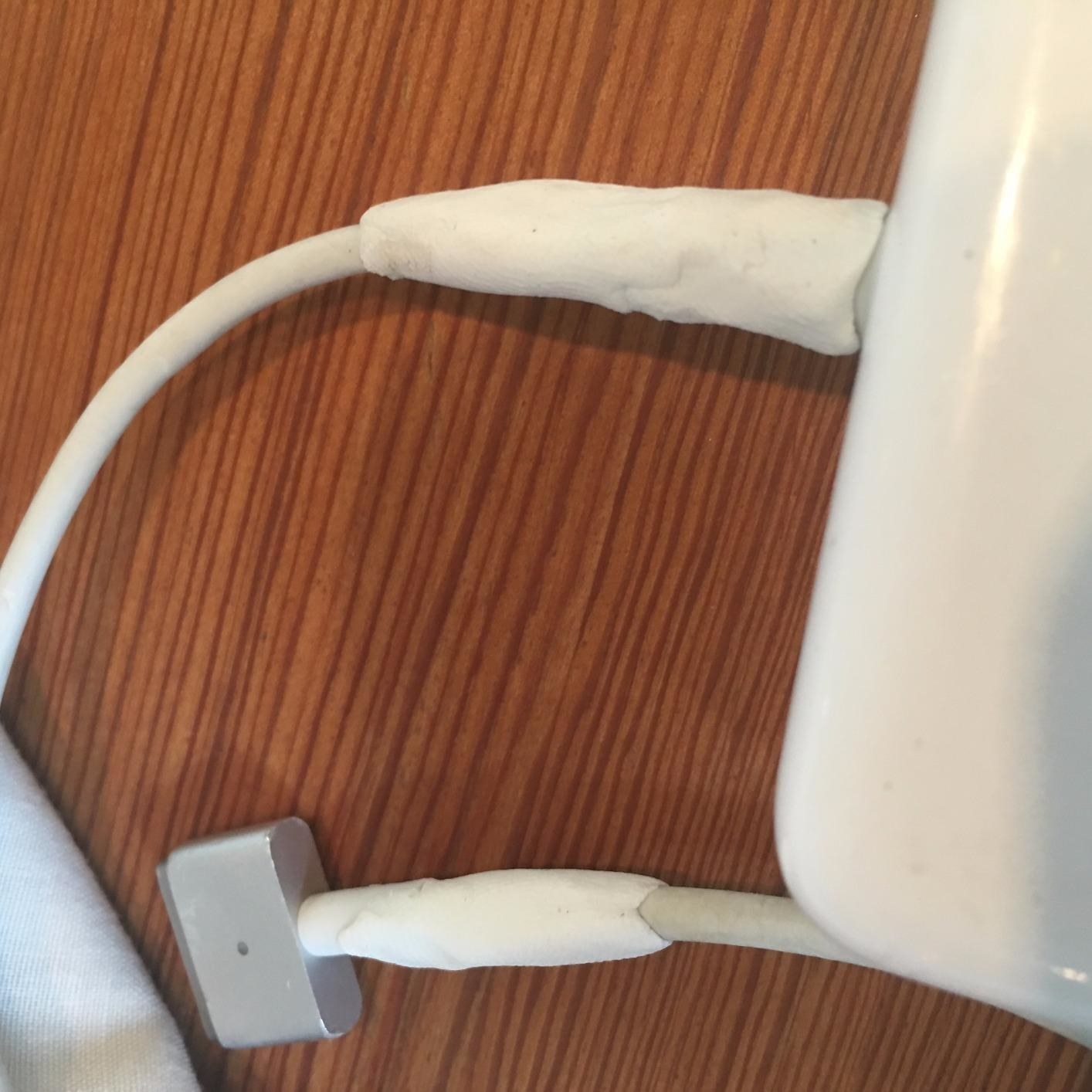 reviewer showing white moldable glue wrapped around the end of chargers