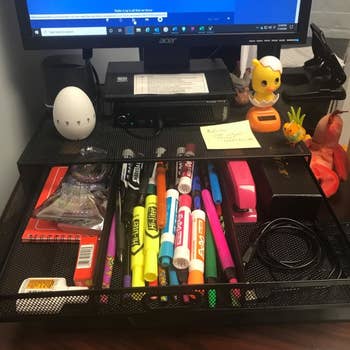 a reviewer photo of the organizer drawer open showing office supplies stored inside 