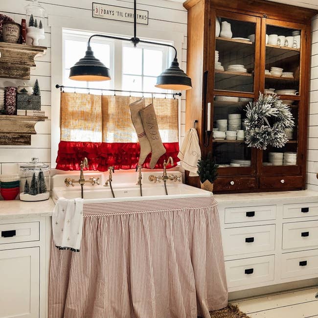 Red and white striped kitchen sink skirt in a festive kitchen 