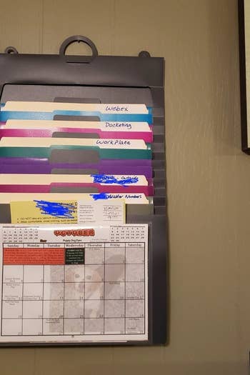 a reviewer photo of the hanging organizer filled with documents 