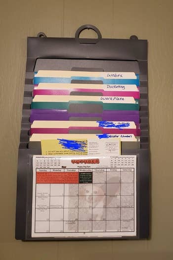 a reviewer photo of the hanging organizer filled with documents 