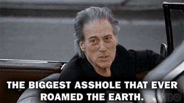 Medium shot of Richard Lewis stopped in a convertible, looking out over the passenger side saying &quot;The biggest asshole that ever roamed the earth&quot;