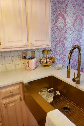 Reviewer's gold sink in pink kitchen 