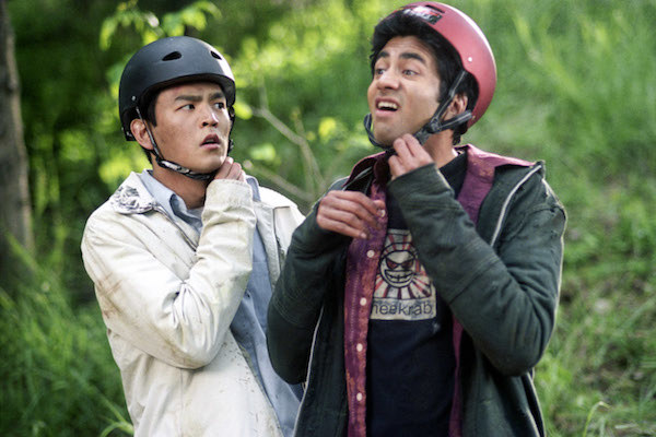 John Cho and Kal Penn taking off their helmets.