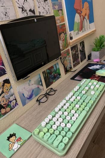 a reviewer photo of their desk set up with the green keyboard and matching mouse 