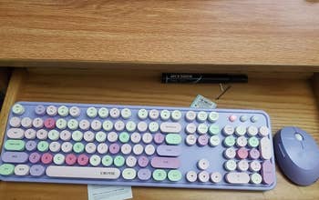 a reviewer photo of the purple keyboard and matching mouse 