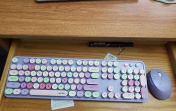 a reviewer photo of the purple keyboard and matching mouse 