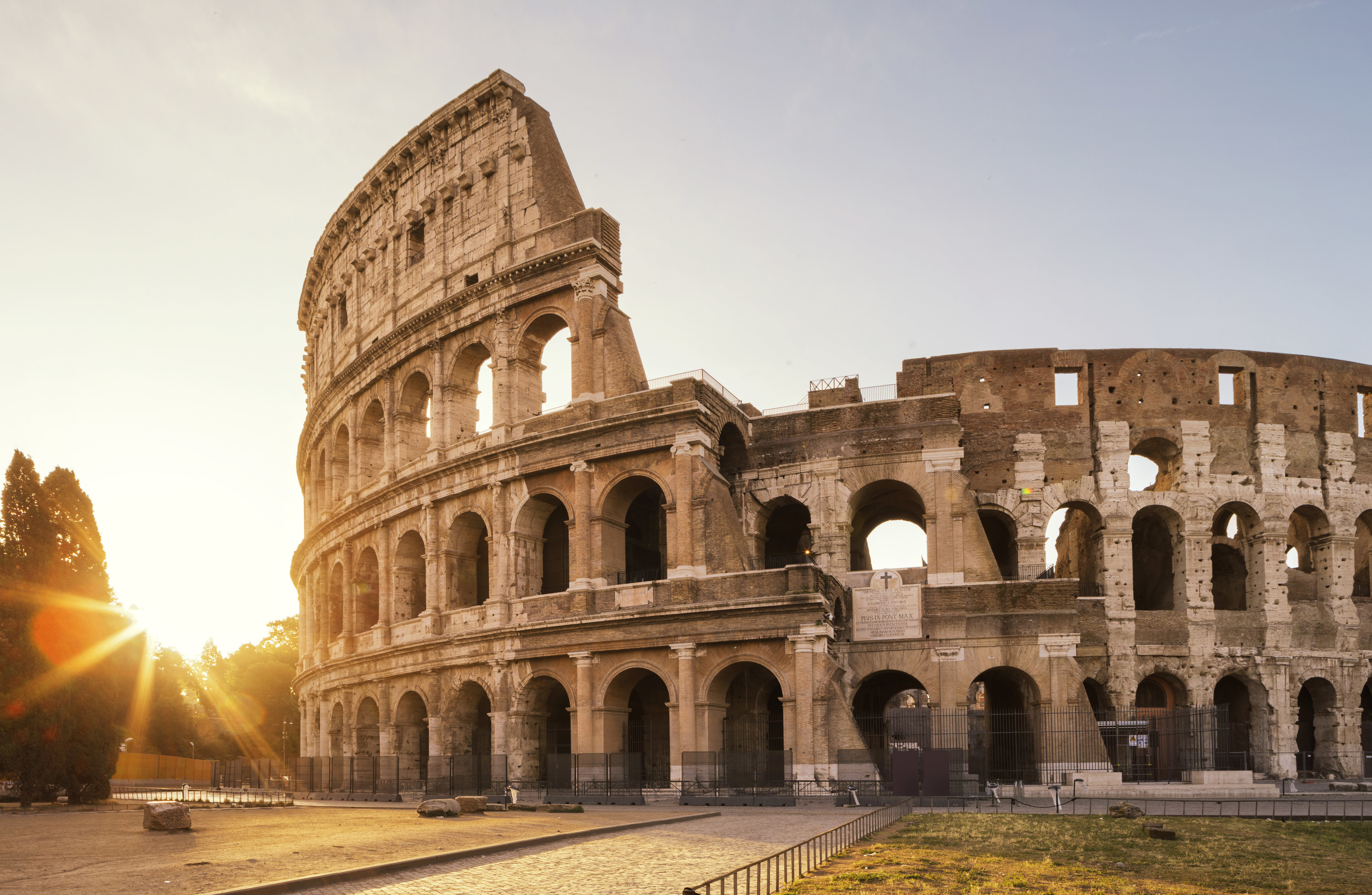 The Roman Colliseum with the sun on the horizon