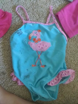 Reviewer's photo showing a stained swimsuit