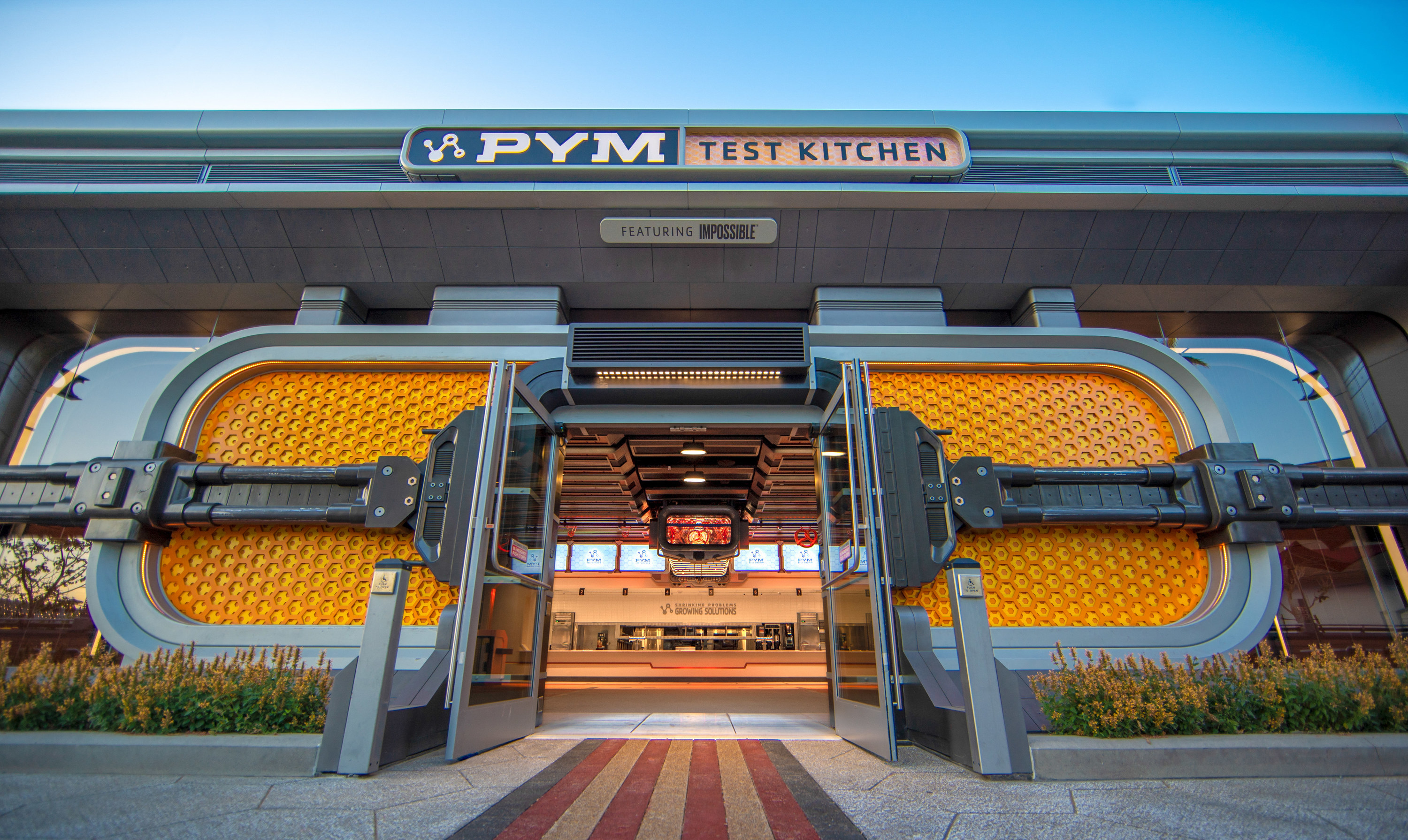 The entrance of Pym Test Kitchen, which is made of a lot of metal and has wide open doors 