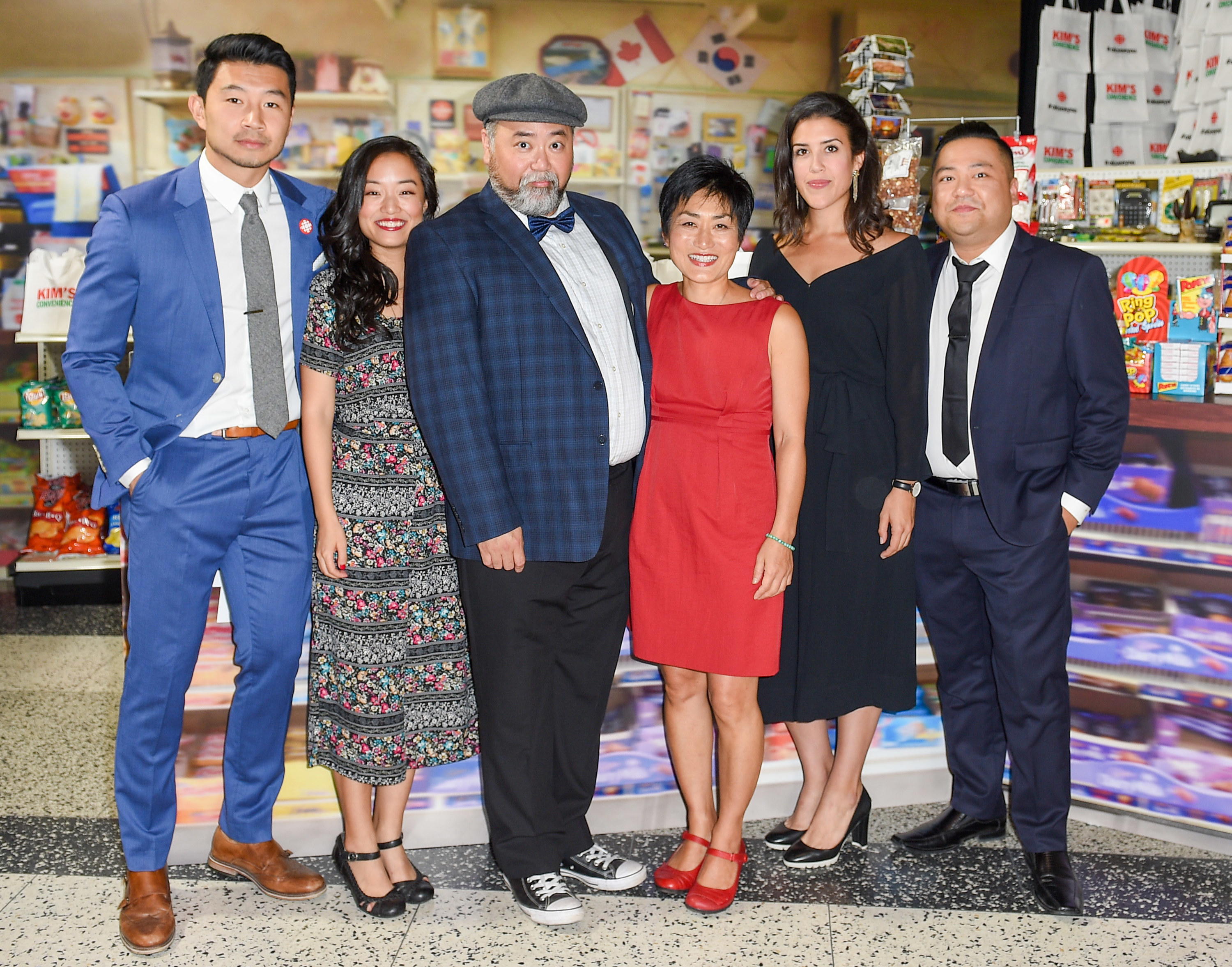 The cast poses together at an event