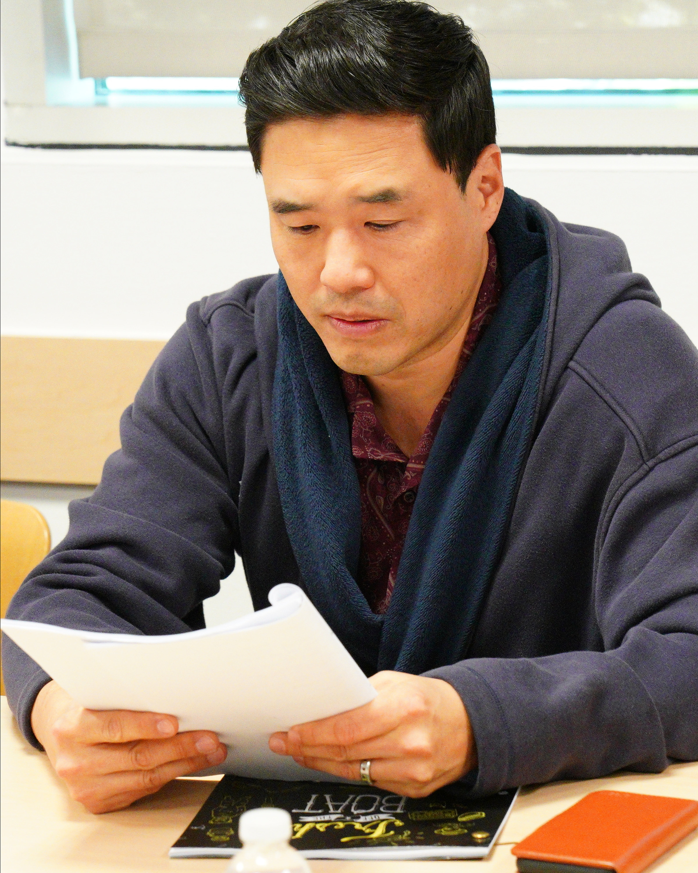 Randall Park reading a script
