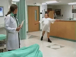 Man twirls in hospital gown