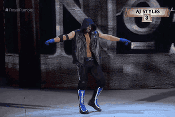AJ Styles takes off his hood and poses