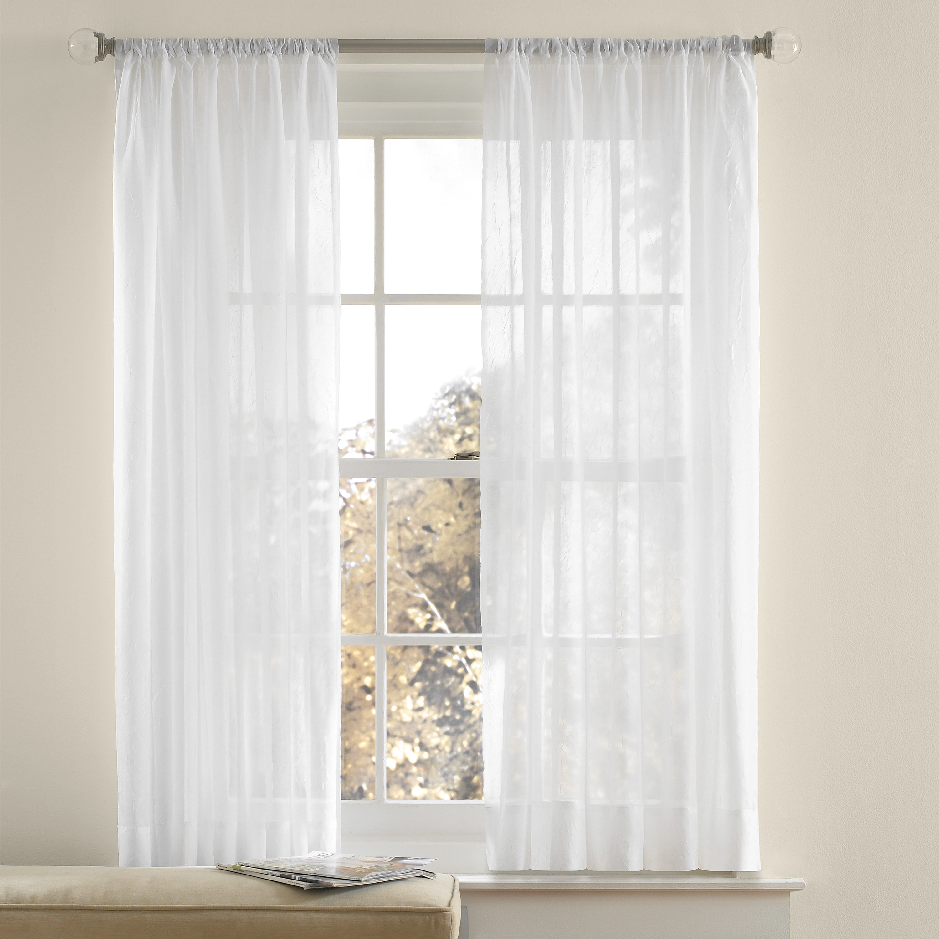 the white curtains hanging over a window