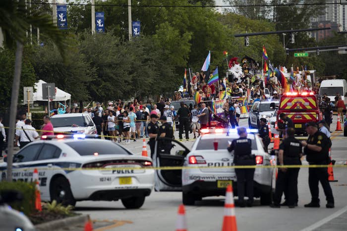 Police cars and police tape are shown amid the Pride parade